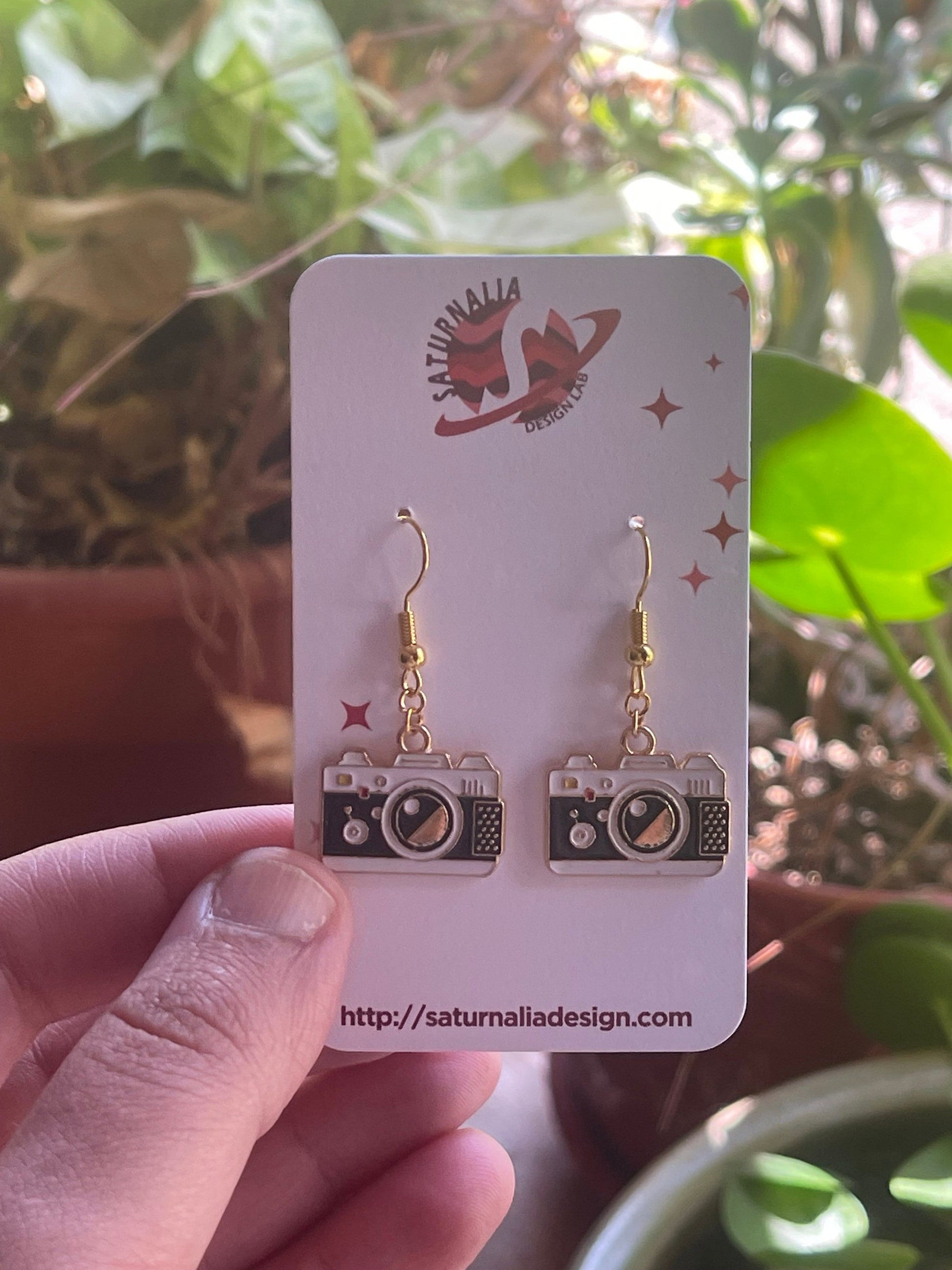 Earrings with an SLR camera charm.